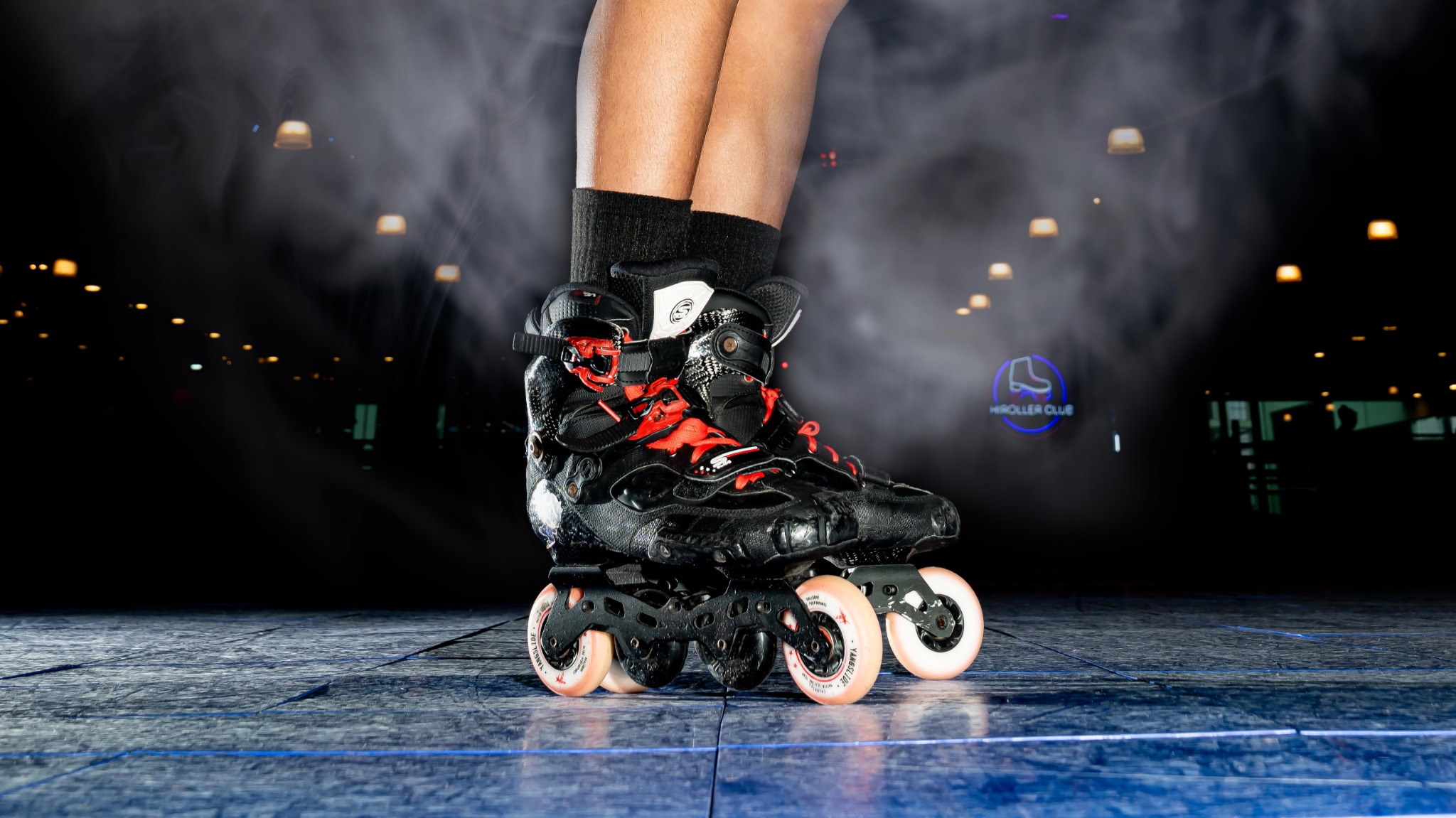 Inline skates on a dark floor with smoke